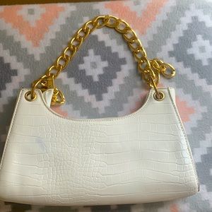 White bag with gold chain